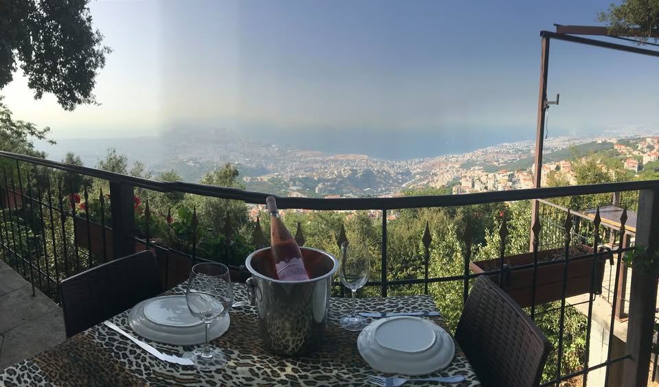 A table set on Tiger’s terrace, with Beirut and the sea below
